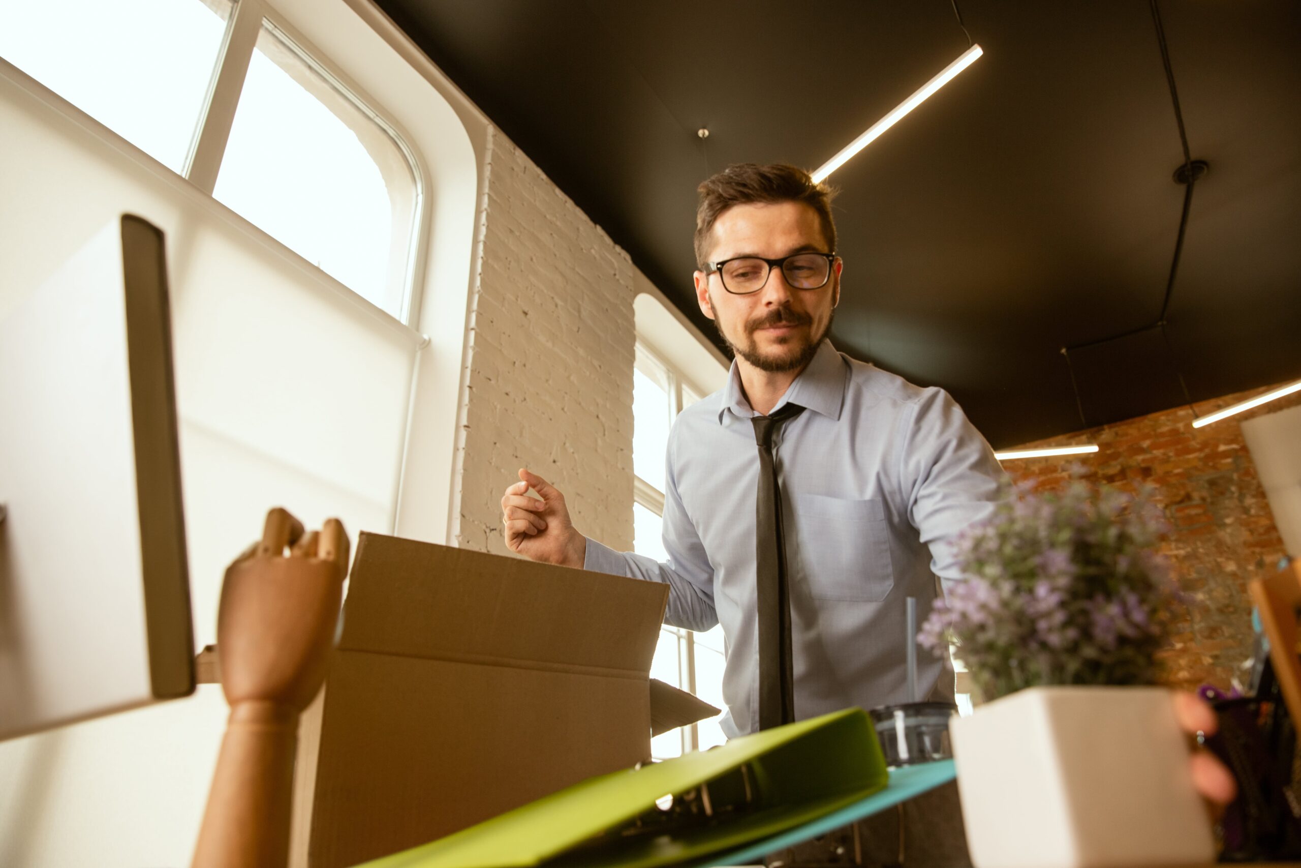 Beginning young businessman moving office 1 min scaled